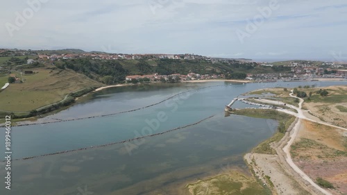 Wallpaper Mural Frontal drone flight over the Suances estuary, revealing the coastal area and the upper part of the town. The shot shows vivid blue inner waters, shoreline and the urban landscape of Suances Torontodigital.ca