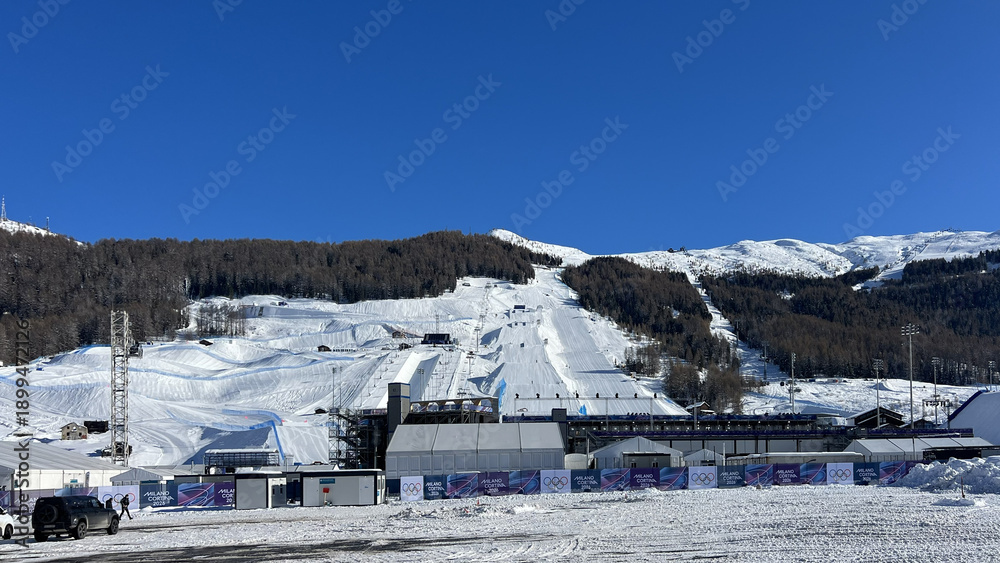 Fototapeta premium Livigno, Italy - February 1, 2026: Snow sports competition area and temporary infrastructure prepared for Milano Cortina 2026 Winter Olympics in Livigno