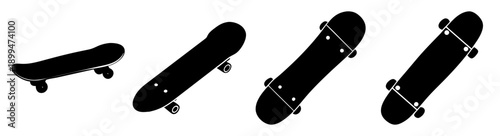 Set of five black skateboards with wheels isolated on white background minimalist flat lay top view