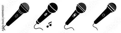Set of four black and silver professional microphones isolated on white background for karaoke singing performance