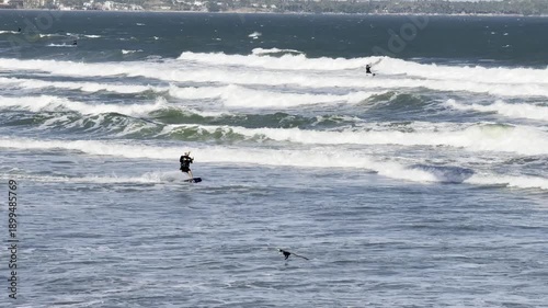 Mui Ne, Vietnam – 02.02.2026: Athlete performing aerial kitesurfing trick in strong wind and surf conditions. Editorial extreme sports travel footage.