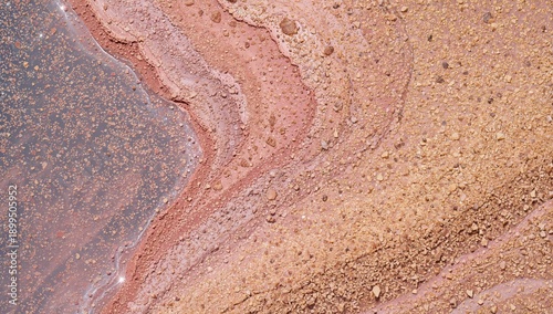 Natural Patterns and Colors in Sand and Water Along the Shoreline at Sunset