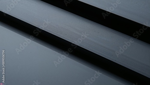 Dark Surface Shows Lines and Textures Under Soft Light in Indoor Setting