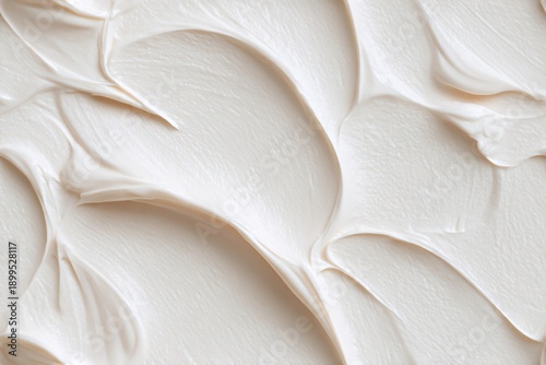 White cream swirl texture background with thick smooth curves. Dessert frosting or cosmetic product concept for food texture, beauty, wellness.