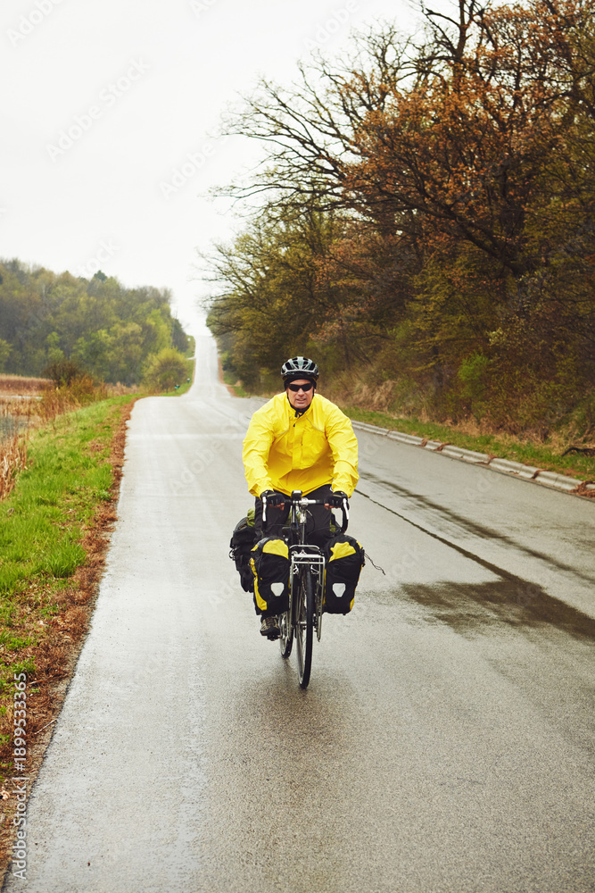 Naklejka premium Mature man, cyclist and bicycle in woods for fitness, tourism exercise and minimalistic travel. Space, male person and cycling for bikepacking, workout safety and adventure activity in countryside
