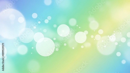 White bokeh lights on blue green yellow gradient background