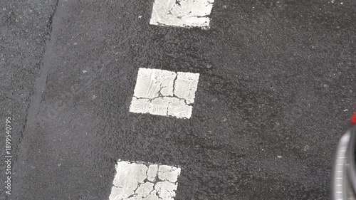 pedestrians crossing a crosswalk on a rainy day with cars that don't stop when they see them , 4k horizontal video footage