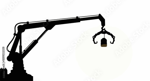 Silhouette of a robotic arm lifting a small object with a hook against a bright background.