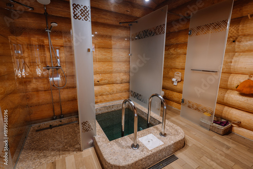 Εκτύπωση καμβά Modern wooden sauna interior featuring a plunge pool, shower area, and frosted g