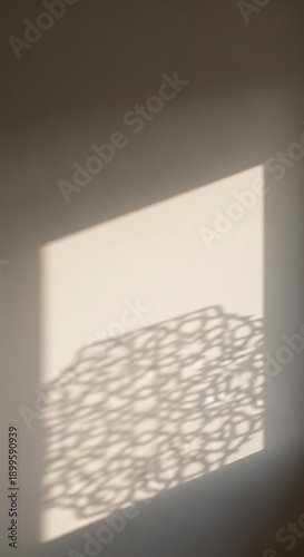 Sunlight creating abstract patterns on a wall, suitable for background textures and minimalist design elements.