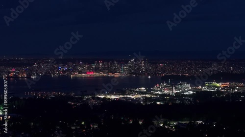 Wallpaper Mural Nighttime view of Vancouver’s downtown skyline seen from Norwood Avenue, with city lights reflecting across the water and creating a calm, cinematic urban atmosphere. Torontodigital.ca