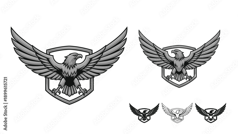Obraz premium Set of heraldic eagle emblems with spread wings and shields in various grayscale tones for logo design and corporate branding identity.