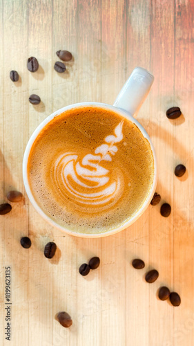 Top View Latte Art Coffee Cup with Swan Design on Wooden Background
