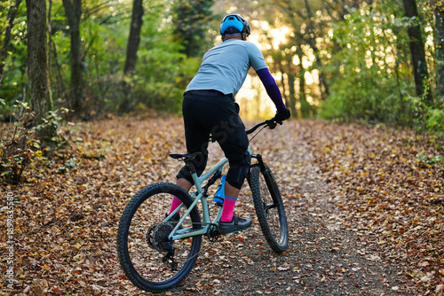 Autumn Forest Mountain Biking: Rider on Trail With Helmet, Gear, And Colorful Socks