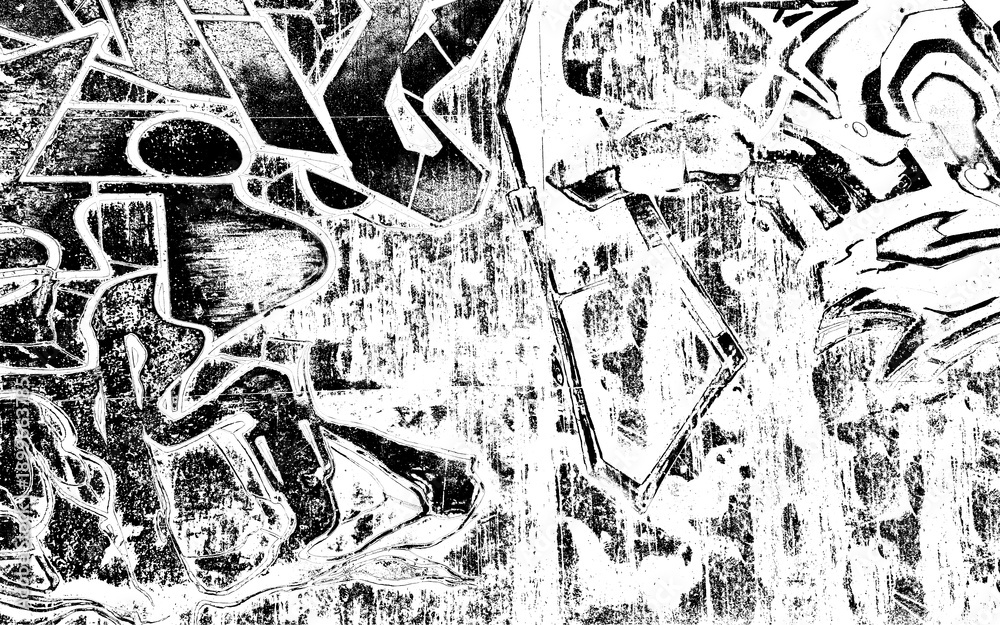 Fototapeta premium A black and white photo of graffiti on a wall. The graffiti is in various shapes and sizes, and the overall mood of the image is chaotic and urban