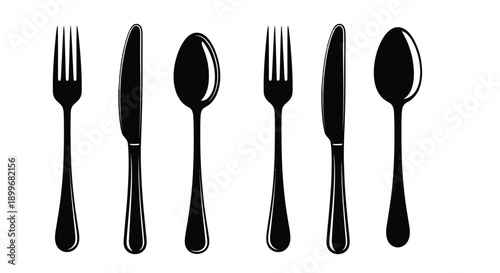 Black cutlery set arranged in a row stark silhouette