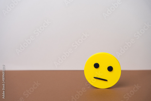 Photography Yellow neutral faced emoji representing dissatisfaction, indifference, or poor customer experience