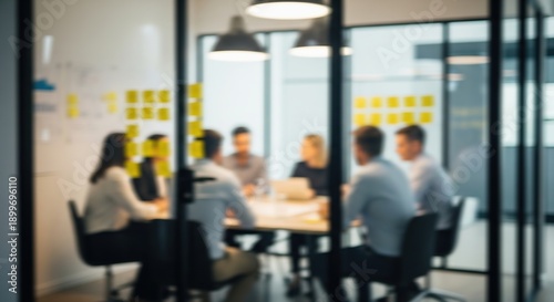 Blurry view of diverse business team collaborating in modern office meeting room