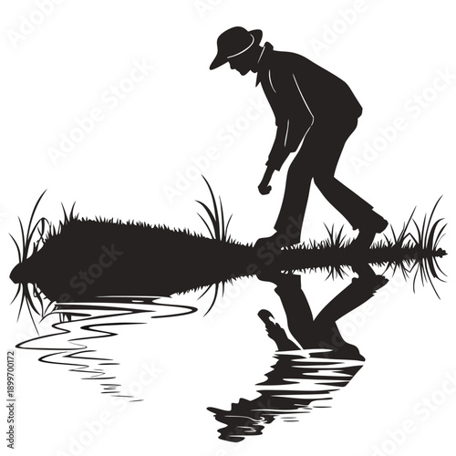 A silhouette of a person bending over to pick something from a log in a body of water