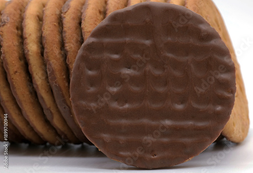 close-up of a chocolate digestive biscuit stack, baked wheat base with rich chocolate coating, a quintessential British treat perfect for dunking in tea or enjoying as a crunchy, indulgent snack