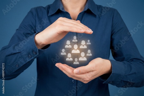 Hands of businesswoman protecting people icons symbolizing human resources and customer care support