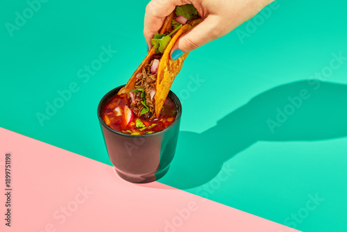 Traditional mexican birria ramen consomme soup and tacos with braised beef. Dip tacos in broth.