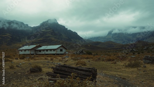 Mountain Landscape With a House in a Remote Area Surrounded by Hills and Clouds