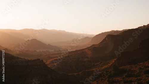 Sunrise Over Rolling Hills and Valleys in a Mountainous Region During Early M...