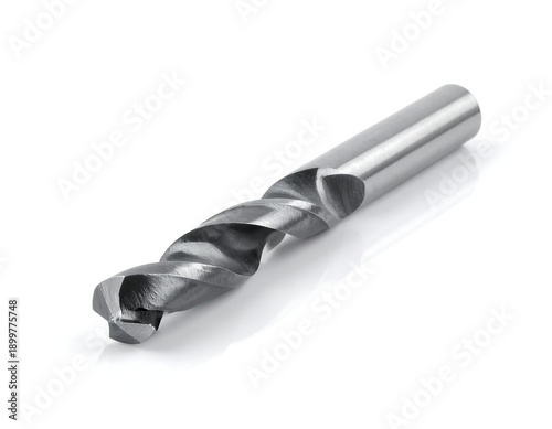 Shiny metal drill bit with helical flutes on white backdrop showing shadow