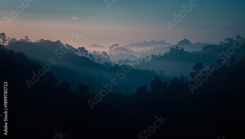 Shadows and Shapes of Mountains in Misty Valleys During Early Morning Light