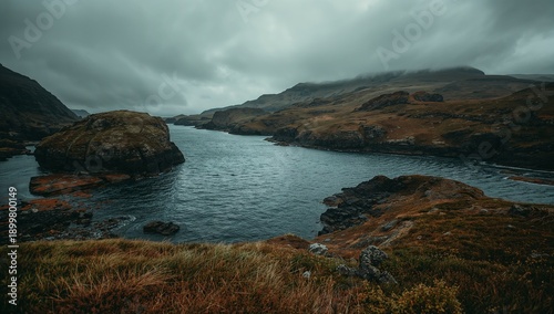 Cloudy Day at a Rocky Coastal Area Near a Calm Bay With Hills in the Distance