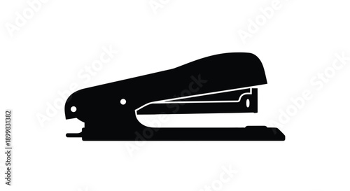A black office stapler shown in a striking silhouette