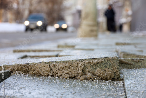 Fotografia Cobbled city street in winter, uneven paving slabs