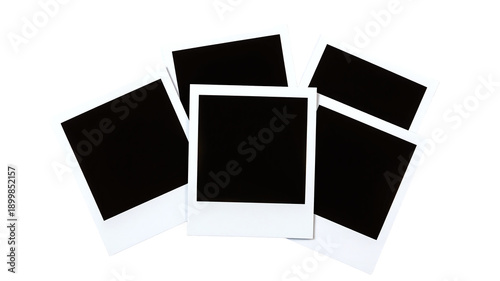 Blank instant photos scattered on a white background, creating a nostalgic and vintage aesthetic with copy space