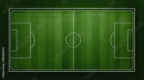 Aerial view of a soccer field with white markings on a green grassy surface surrounded by a dark environment