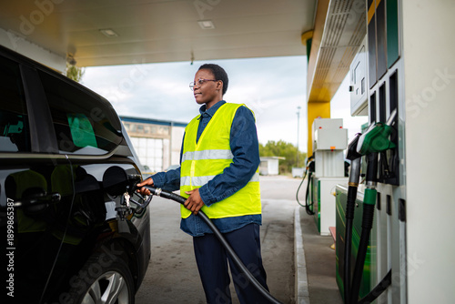 Wallpaper Mural Gas station worker refueling car from fuel pump Torontodigital.ca