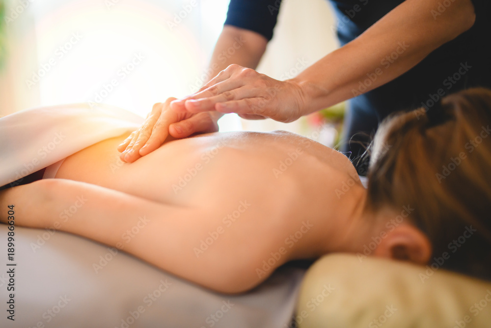 Fototapeta premium Professional masseur makes massage to a child girl