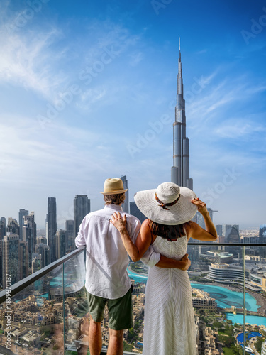 Photography Rear view of an elegant tourist couple looking at the panoramic view of the skyl