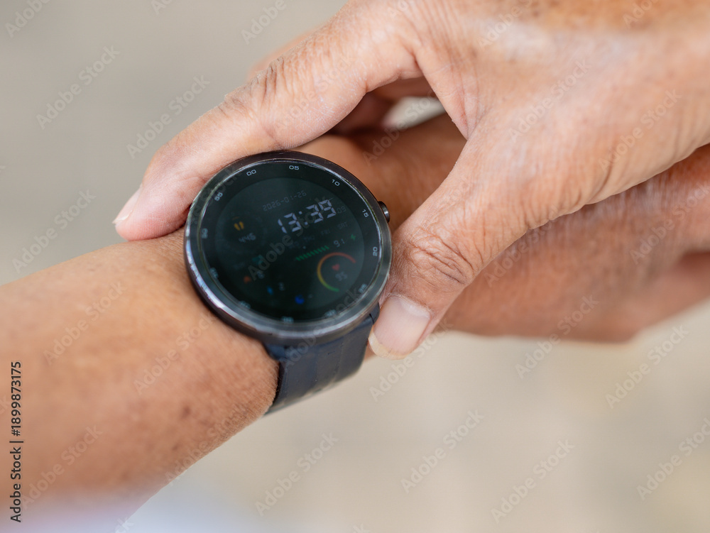 Fototapeta premium Close up hand people senior checking fitness tracking on smartwatch for concept body care, exercise, wellness and health care. Authenticity person female using technology for healthy well being