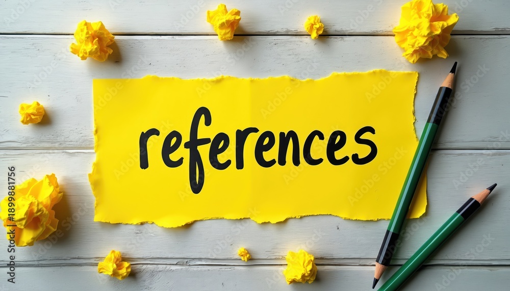 Naklejka premium Yellow paper with the word references. Pencils and crumpled paper balls on white wood table. Idea, citation, source, education concept. Research, information, writing.