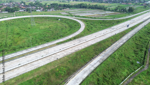 Photography Aerial drone view highway with a grassy median and a large curve