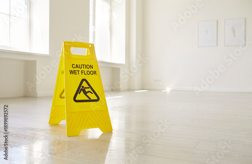 Cuadro en lienzo Caution wet floor sign warning of slippery danger in empty office room