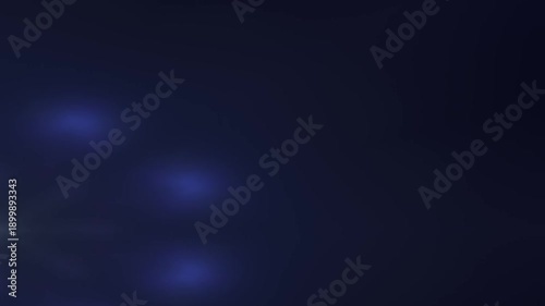 observing a soft blue circular glow in a dark studio setting