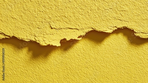 Peeling yellow plaster wall texture with cracked paint surface and rough concrete detail