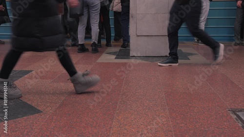 Crowded subway platform with anonymous commuters walking during rush hour