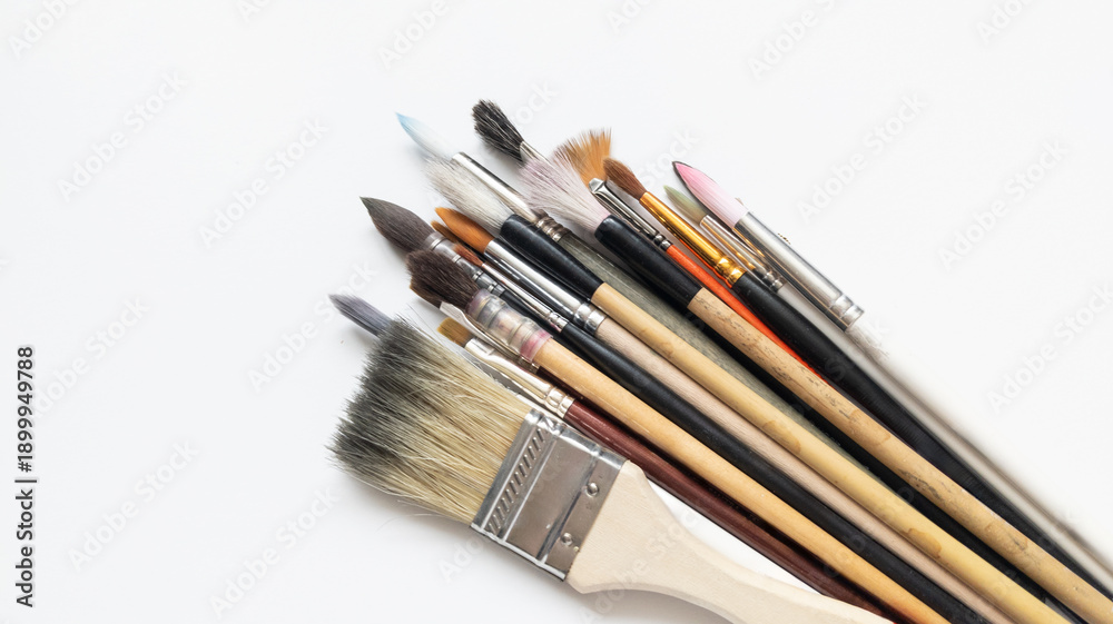 Obraz premium Art brushes isolated on a white background, art supplies set for painting. Calligraphy, squirrel, and synthetic brushes.