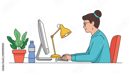 Young woman with her hair in a bun, focused on working at her computer, with a plant and water bottle on a clean, modern desk.