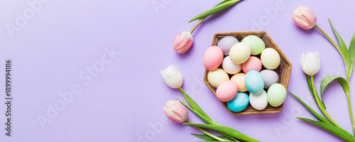 Wallpaper Mural Happy Easter composition. Easter eggs in basket on colored table with yellow Tulips. Natural dyed colorful eggs background top view with copy space Torontodigital.ca
