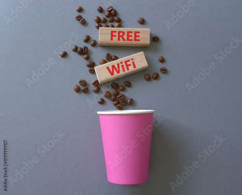 Fee Wifi symbol. Concept words Fee Wifi on beautiful wooden picture frame. Beautiful grey background with coffee cup and coffee beans. Business and Fee Wifi concept. Copy space.