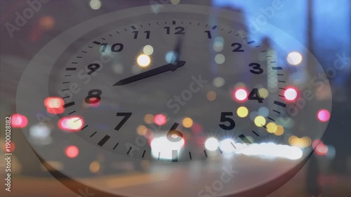 Playback starting, analog clock rotating hands while traffic bokeh shifting, showing time passage
